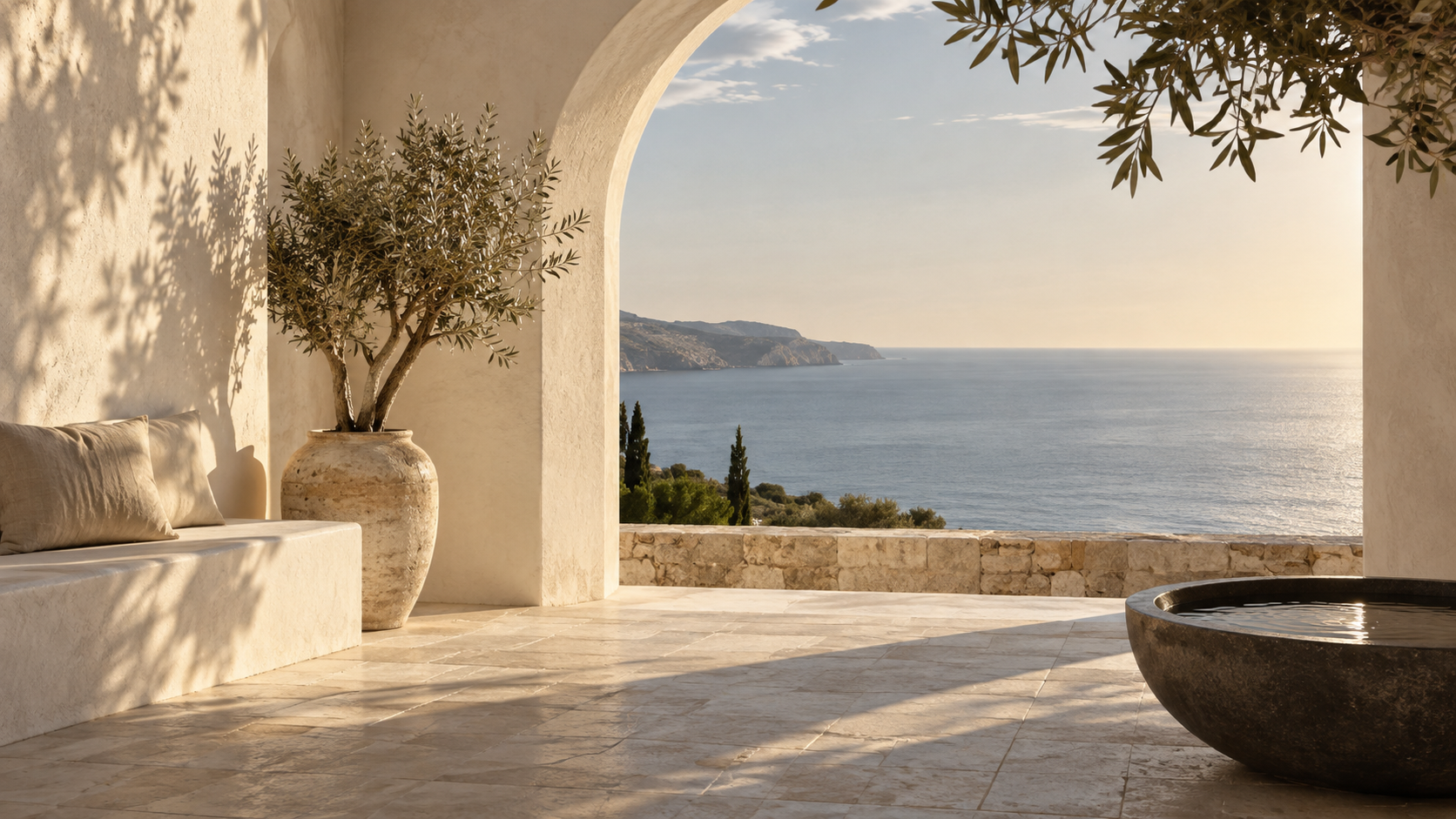 A sunlit courtyard with space for quiet conversation beside the sea