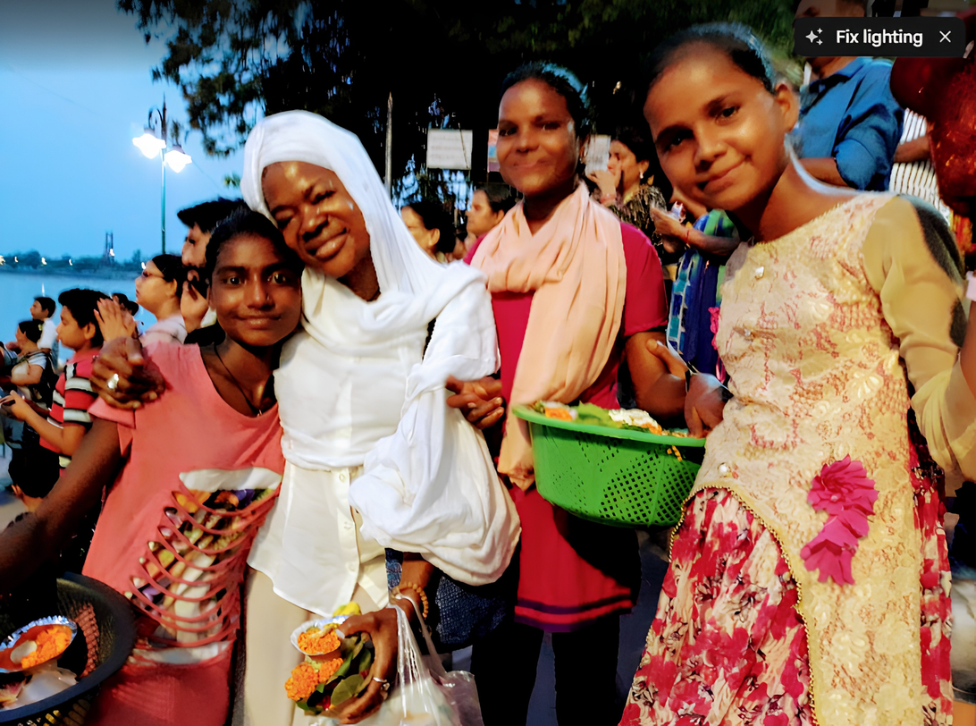 Dr. Blossom A. Burton with young people beside the Ganga River in India