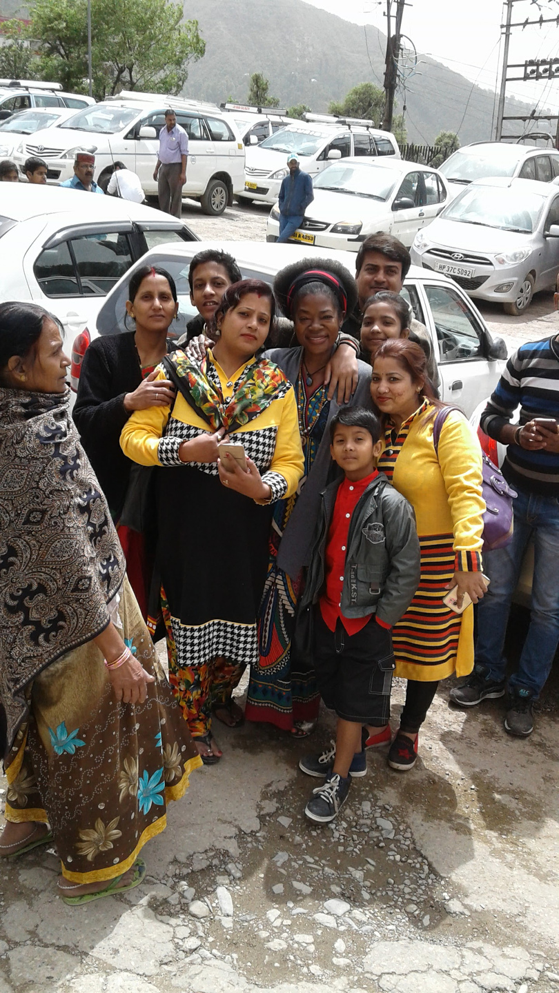 Dr. Blossom A. Burton gathered closely with women and a child in India